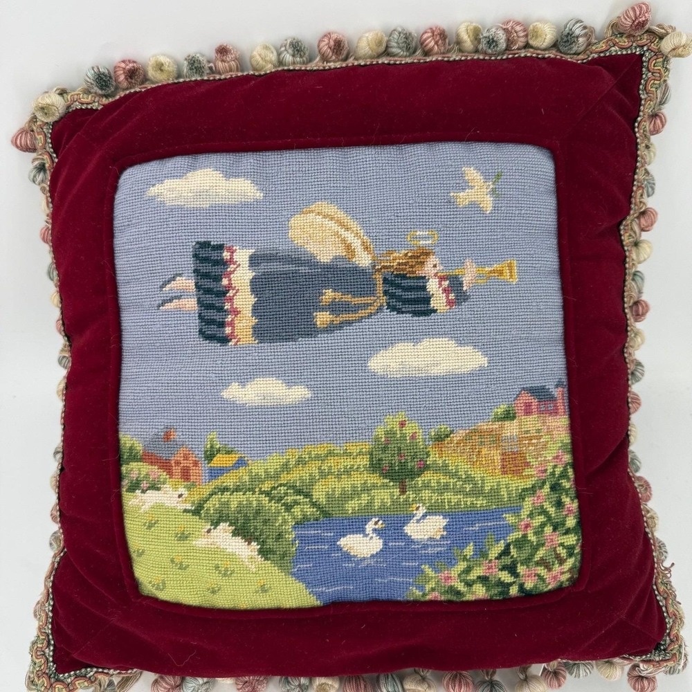 Needlepoint pillow featuring a folk art angel motif dark red velvet background
